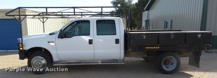 image for item L4100 1999 Ford F550 Super Duty XLT Crew Cab flatbed truck