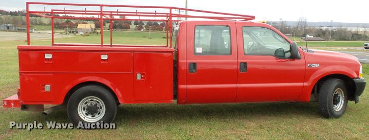 image for item K3426 2003 Ford F250 Super Duty Crew Cab flat bed truck