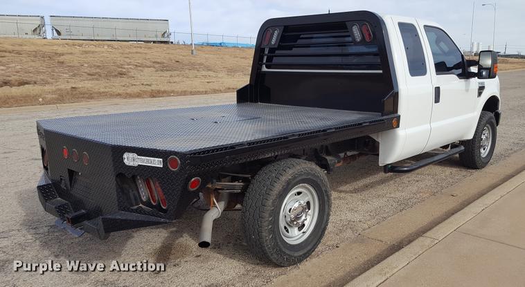 image for item L1726 2010 Ford F250 Super Duty SuperCab flatbed pickup truck