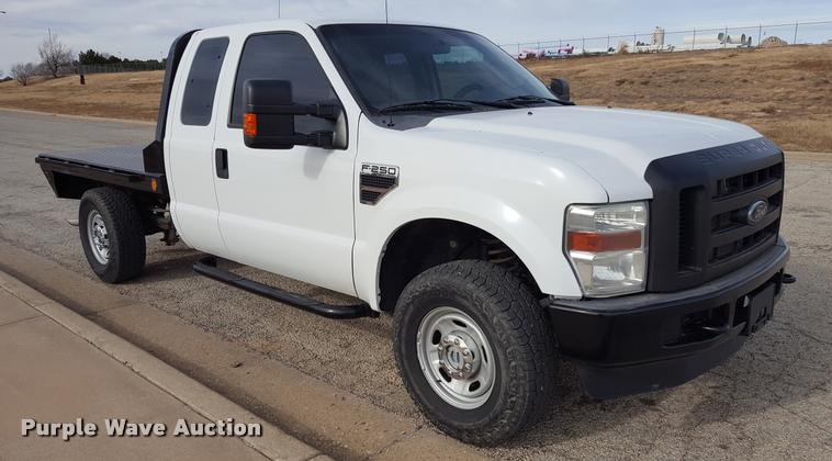 image for item L1726 2010 Ford F250 Super Duty SuperCab flatbed pickup truck