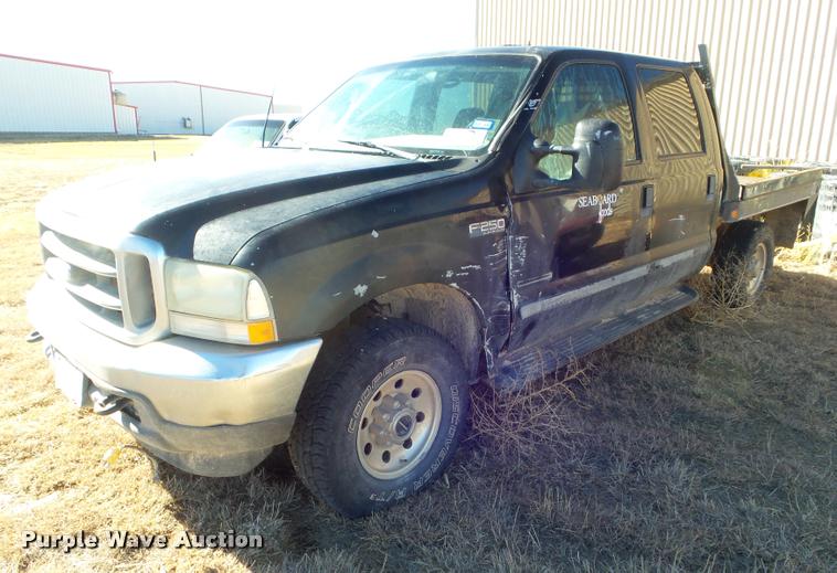 image for item DA7578 2002 Ford F250 Super Duty Crew Cab flatbed pickup truck