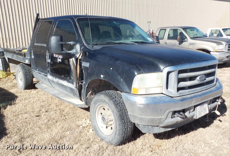 image for item DA7578 2002 Ford F250 Super Duty Crew Cab flatbed pickup truck
