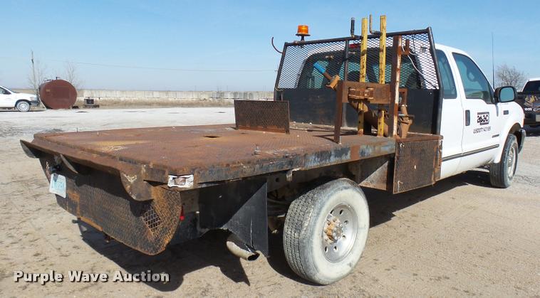 image for item DB2353 1999 Ford F250 Super Duty SuperCab flatbed pickup truck