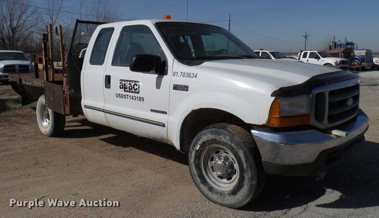 image for item DB2353 1999 Ford F250 Super Duty SuperCab flatbed pickup truck