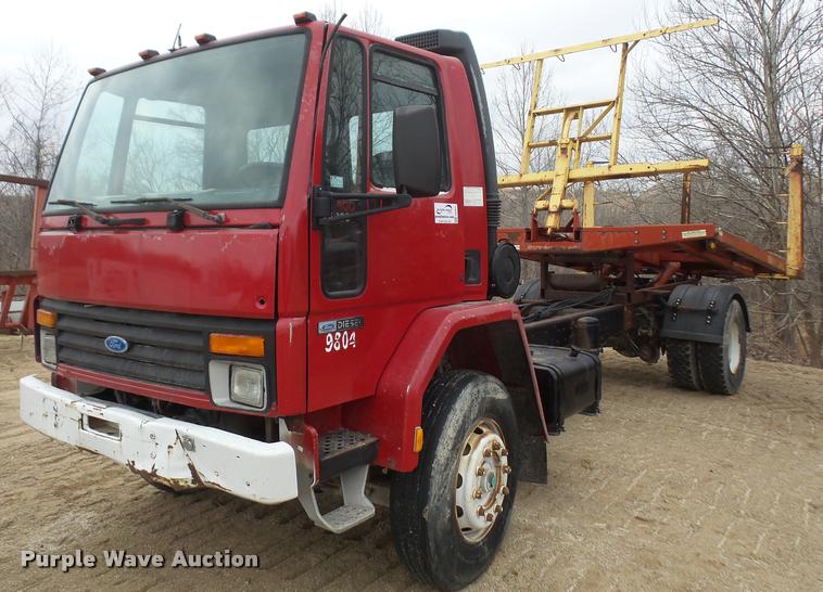 image for item DB2911 1990 Ford Cargo 8000 truck with New Holland 1060 bale stacker retriever