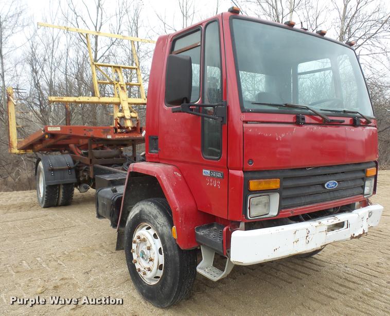 image for item DB2911 1990 Ford Cargo 8000 truck with New Holland 1060 bale stacker retriever