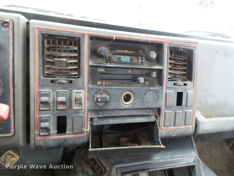 image for item DB2911 1990 Ford Cargo 8000 truck with New Holland 1060 bale stacker retriever