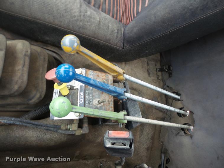 image for item DB2911 1990 Ford Cargo 8000 truck with New Holland 1060 bale stacker retriever