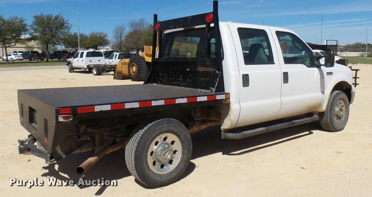 image for item DB2458 2007 Ford F250 Super Duty Crew Cab flatbed pickup truck