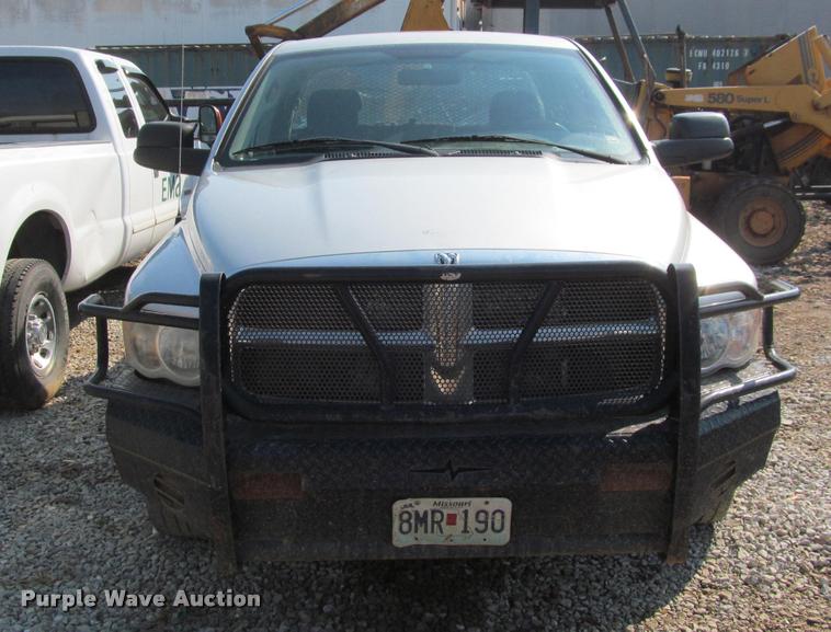 image for item J2597 2005 Dodge Ram 2500 Quad Cab flatbed pickup truck