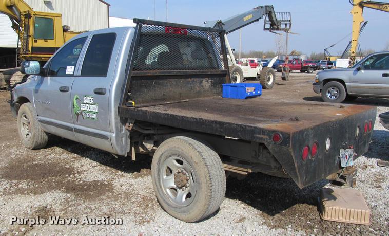 image for item J2597 2005 Dodge Ram 2500 Quad Cab flatbed pickup truck