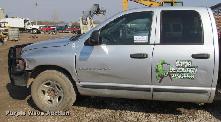 image for item J2597 2005 Dodge Ram 2500 Quad Cab flatbed pickup truck