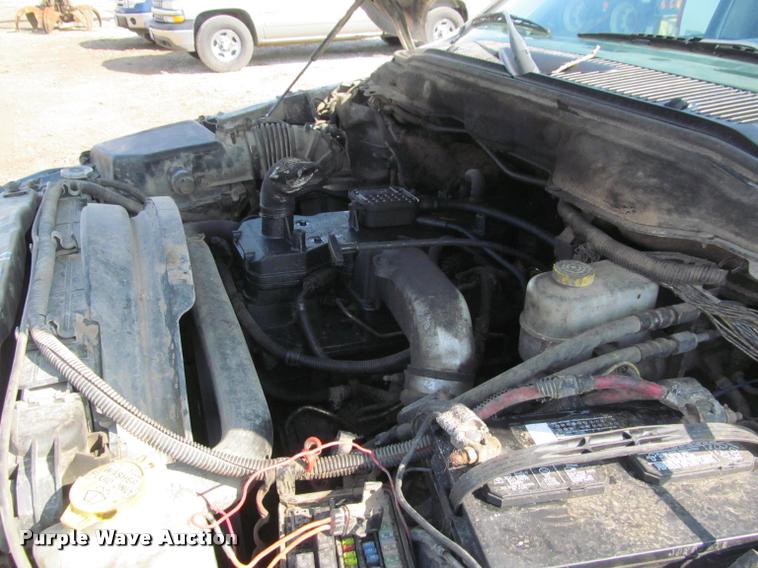 image for item J2597 2005 Dodge Ram 2500 Quad Cab flatbed pickup truck