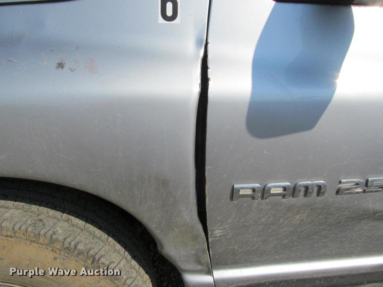 image for item J2597 2005 Dodge Ram 2500 Quad Cab flatbed pickup truck