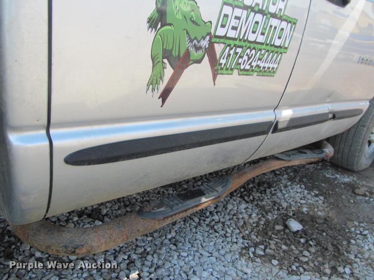 image for item J2597 2005 Dodge Ram 2500 Quad Cab flatbed pickup truck