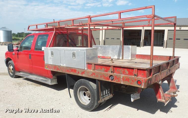 image for item DA6313 1999 Ford F350 Super Duty Crew Cab flatbed pickup truck