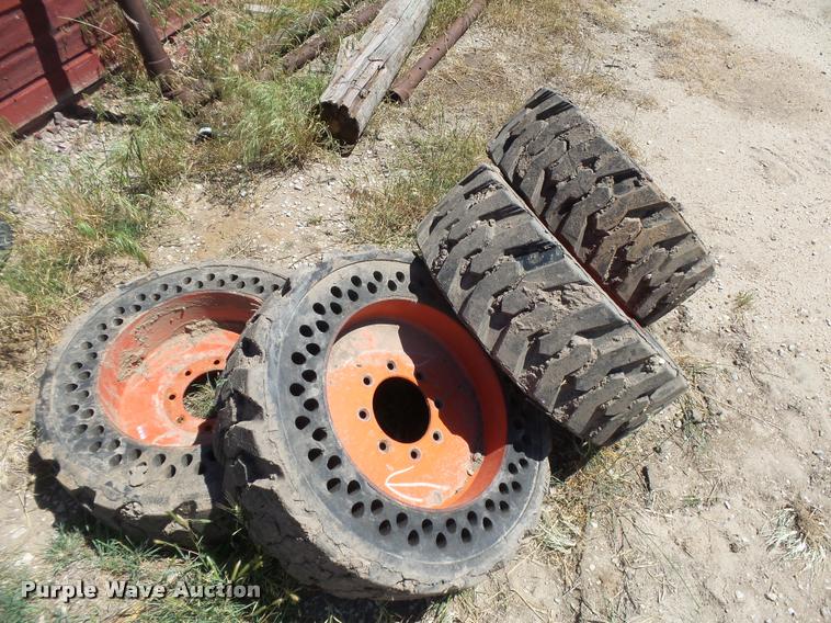 image for item DE9049 (4) 31x6x10/10-16.5 solid skid steer tires and wheels
