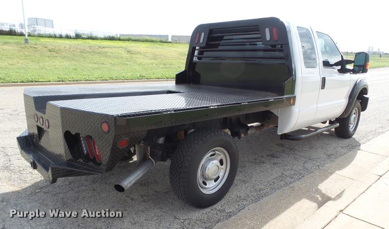 image for item DL9032 2014 Ford F250 Super Duty SuperCab flatbed pickup truck