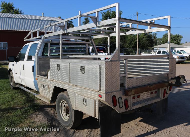 image for item DD0196 1999 Ford F350 Super Duty Crew Cab flatbed pickup truck