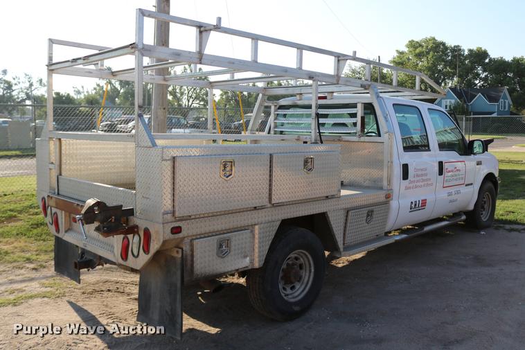 image for item DD0196 1999 Ford F350 Super Duty Crew Cab flatbed pickup truck