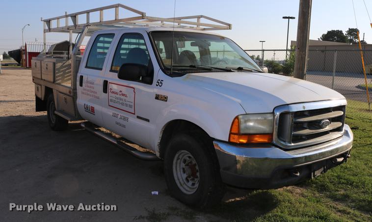 image for item DD0196 1999 Ford F350 Super Duty Crew Cab flatbed pickup truck