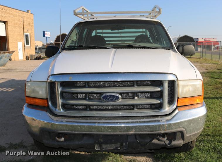 image for item DD0196 1999 Ford F350 Super Duty Crew Cab flatbed pickup truck