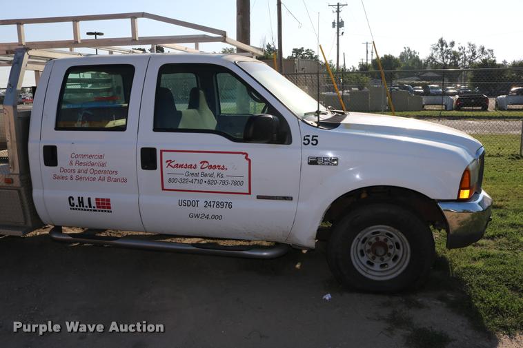 image for item DD0196 1999 Ford F350 Super Duty Crew Cab flatbed pickup truck