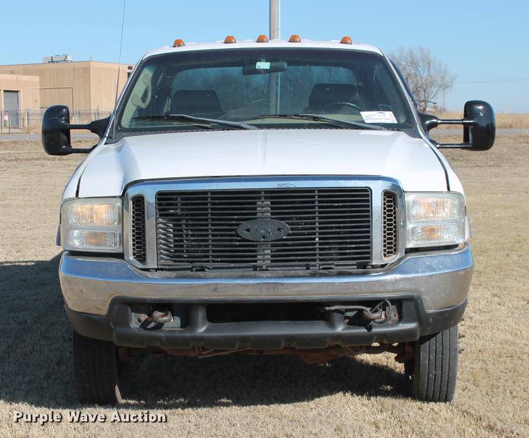 image for item DB5095 1999 Ford F450 Super Duty XLT Crew Cab flatbed truck