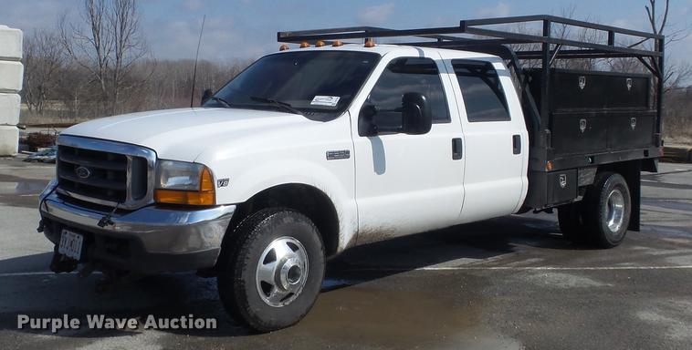 image for item DC7393 1999 Ford F350 Super Duty Lariat Crew Cab flatbed pickup truck