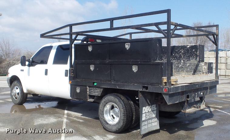 image for item DC7393 1999 Ford F350 Super Duty Lariat Crew Cab flatbed pickup truck