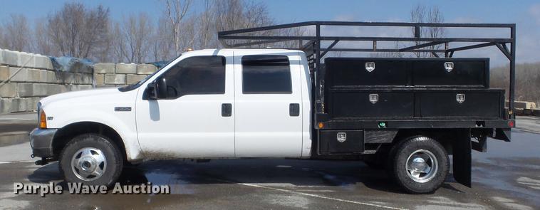 image for item DC7393 1999 Ford F350 Super Duty Lariat Crew Cab flatbed pickup truck