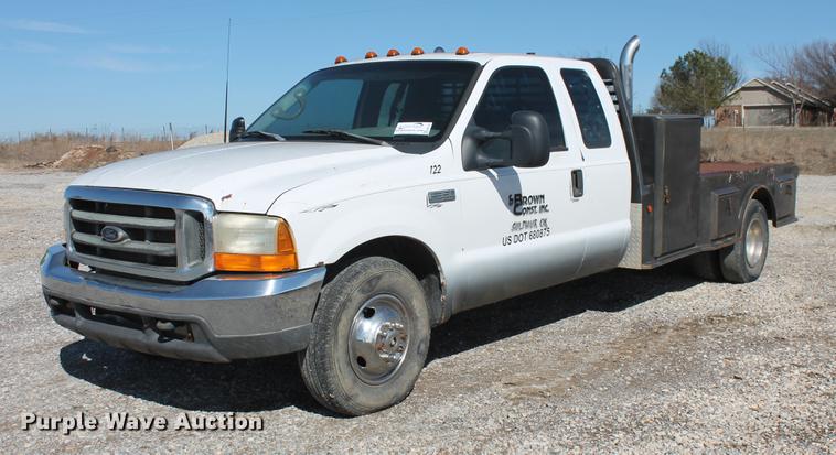 image for item DB5144 1999 Ford F350 Super Duty XLT SuperCab flatbed pickup truck
