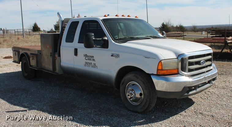 image for item DB5144 1999 Ford F350 Super Duty XLT SuperCab flatbed pickup truck