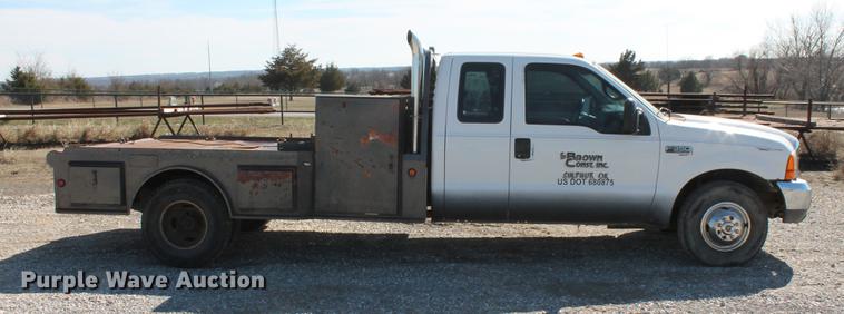 image for item DB5144 1999 Ford F350 Super Duty XLT SuperCab flatbed pickup truck