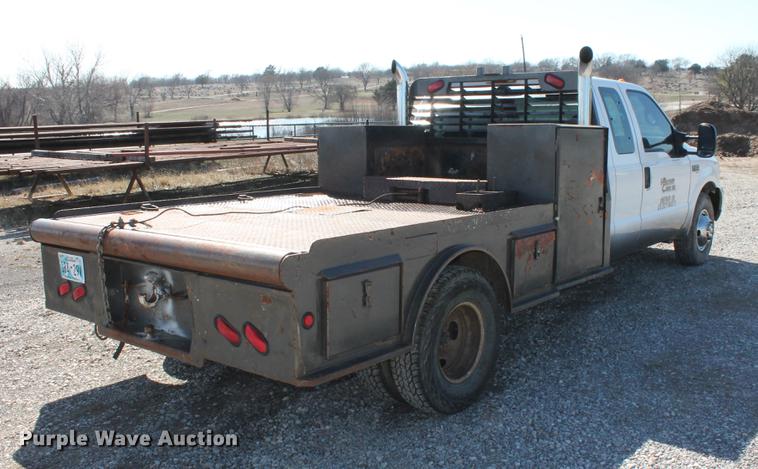 image for item DB5144 1999 Ford F350 Super Duty XLT SuperCab flatbed pickup truck