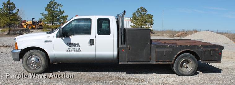 image for item DB5144 1999 Ford F350 Super Duty XLT SuperCab flatbed pickup truck