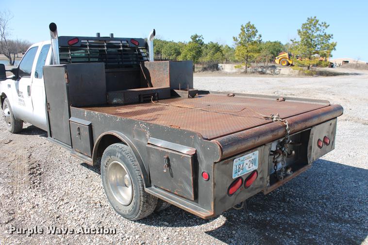 image for item DB5144 1999 Ford F350 Super Duty XLT SuperCab flatbed pickup truck