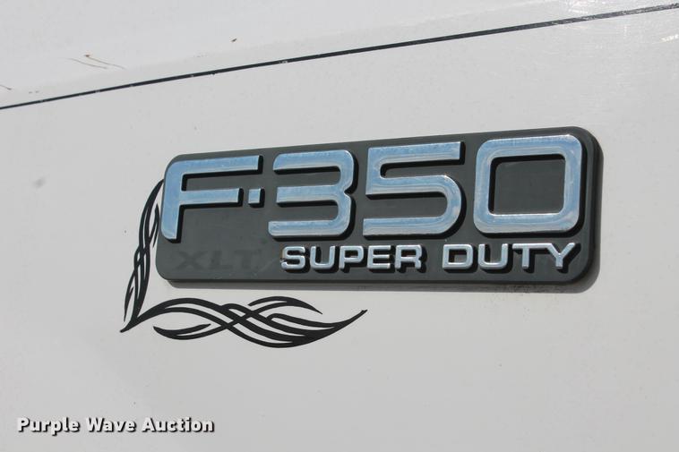image for item DB5144 1999 Ford F350 Super Duty XLT SuperCab flatbed pickup truck