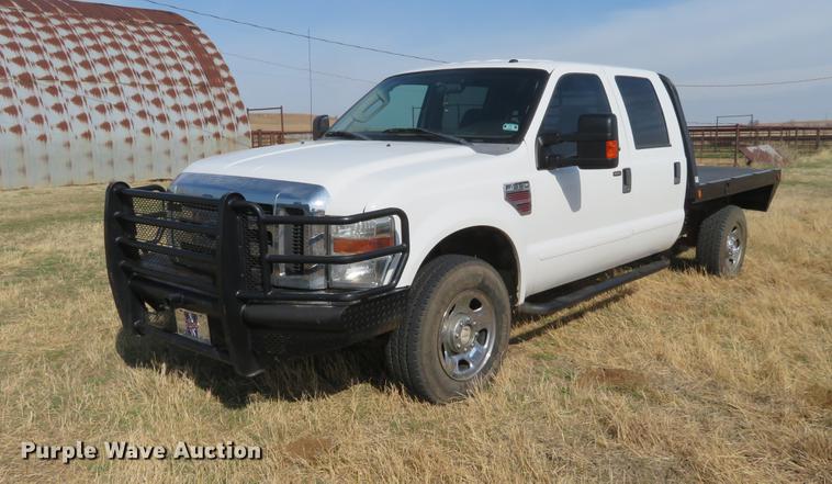 image for item DC0986 2009 Ford F350 Super Duty Crew Cab flatbed pickup truck