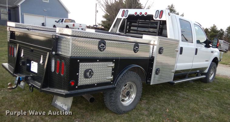 image for item DC0424 2004 Ford F350 Super Duy Lariat Crew Cab flatbed pickup truck
