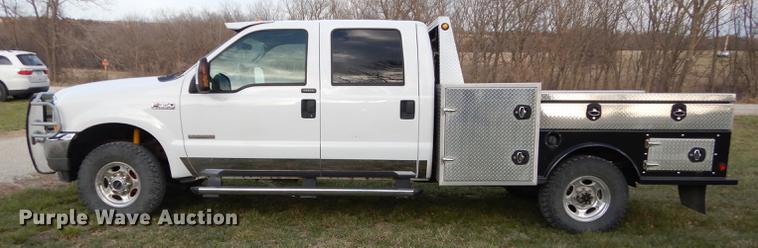 image for item DC0424 2004 Ford F350 Super Duy Lariat Crew Cab flatbed pickup truck