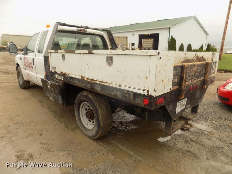image for item DD2770 1999 Ford F350 Super Duty XLT SuperCab flatbed pickup truck