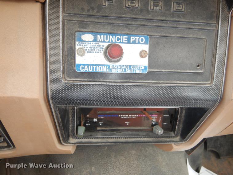 image for item DE1758 1984 Ford F700 flatbed truck with pot hole patcher