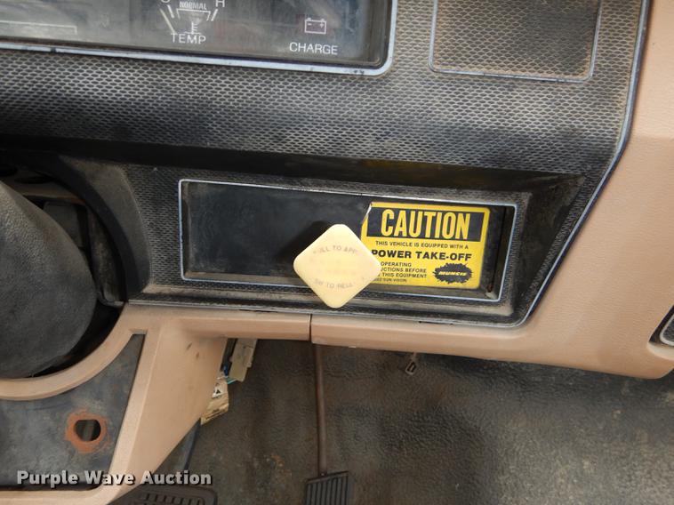 image for item DE1758 1984 Ford F700 flatbed truck with pot hole patcher