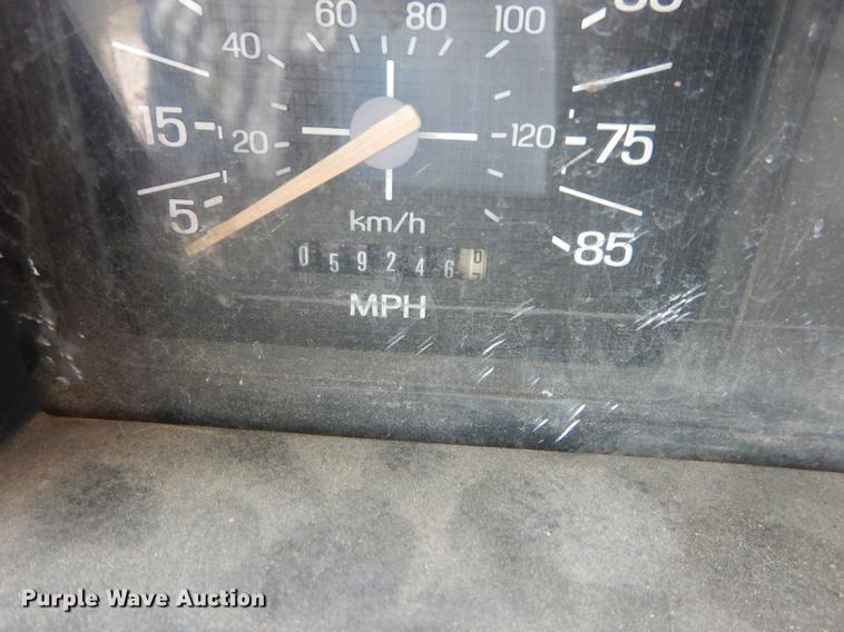 image for item DE1758 1984 Ford F700 flatbed truck with pot hole patcher