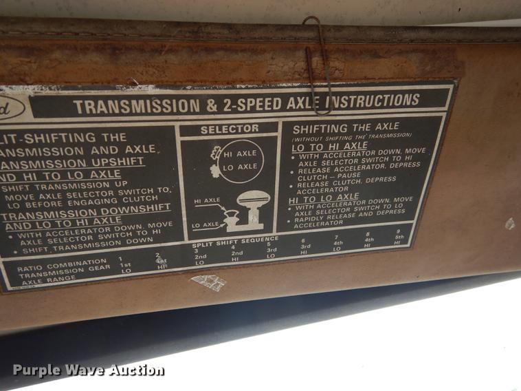 image for item DE1758 1984 Ford F700 flatbed truck with pot hole patcher