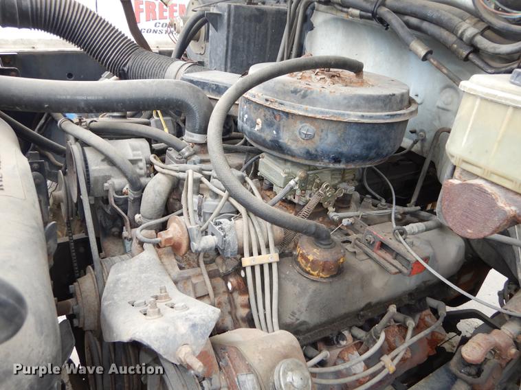 image for item DE1758 1984 Ford F700 flatbed truck with pot hole patcher