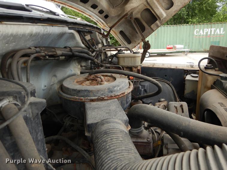 image for item DE1758 1984 Ford F700 flatbed truck with pot hole patcher