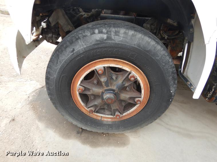 image for item DE1758 1984 Ford F700 flatbed truck with pot hole patcher