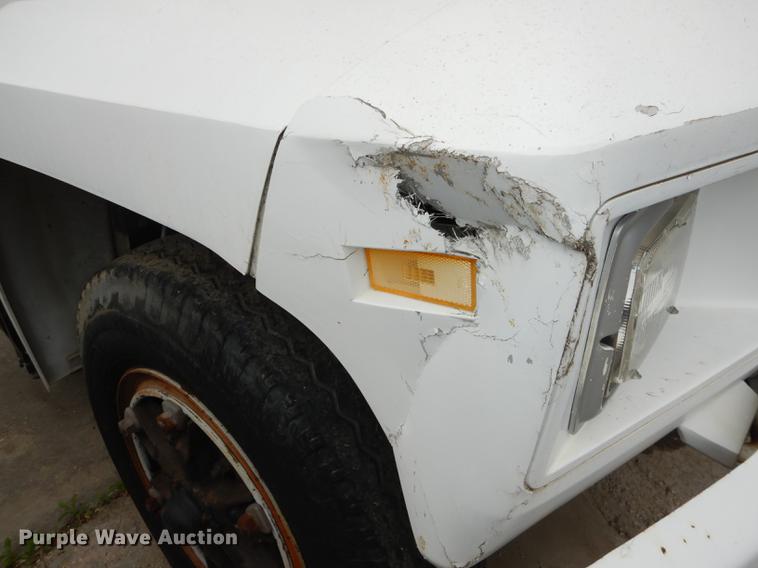 image for item DE1758 1984 Ford F700 flatbed truck with pot hole patcher